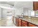 Well-appointed kitchen featuring granite counters, tiled floors, dark wood cabinets, and a stainless steel sink at 8005 Pepperidge Ln, Port Richey, FL 34668