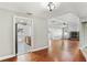 Bright living area with hardwood floors, open floor plan, leading to a modern kitchen and cozy fireplace at 8005 Pepperidge Ln, Port Richey, FL 34668