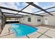 View of a backyard pool with a screened enclosure at 8005 Pepperidge Ln, Port Richey, FL 34668