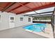 Backyard view of private in-ground pool with screened enclosure at 8005 Pepperidge Ln, Port Richey, FL 34668