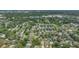 A scenic aerial view of a neighborhood shaded by mature trees, highlighting the river and cityscape nearby at 8502 N Hyaleah Rd, Tampa, FL 33617