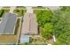 Overhead view of home showcasing backyard shed, mature trees, and fenced yard at 8502 N Hyaleah Rd, Tampa, FL 33617