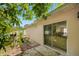 Backyard exterior view with sliding glass door entry and shade trees at 8502 N Hyaleah Rd, Tampa, FL 33617