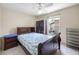 Bedroom with tiled floors, ceiling fan, and window for natural light at 8502 N Hyaleah Rd, Tampa, FL 33617