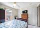 Bedroom featuring a ceiling fan, window, and dresser for ample storage at 8502 N Hyaleah Rd, Tampa, FL 33617