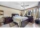Cozy bedroom featuring a wooden bed frame, a ceiling fan and dresser at 8502 N Hyaleah Rd, Tampa, FL 33617