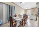 Bright dining room with tile flooring, a classic dining table, and natural light from the window at 8502 N Hyaleah Rd, Tampa, FL 33617