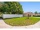 View of the home's exterior, showcasing its well-maintained front lawn and extended driveway at 8502 N Hyaleah Rd, Tampa, FL 33617