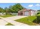Quaint single-story home featuring a one-car garage, lovely landscaping, and a fenced yard at 8502 N Hyaleah Rd, Tampa, FL 33617