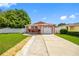 Inviting single-story home featuring a one-car garage, and well-manicured lawn at 8502 N Hyaleah Rd, Tampa, FL 33617