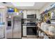Kitchen featuring stainless steel refrigerator and oven, plus ample pantry storage solutions at 8502 N Hyaleah Rd, Tampa, FL 33617