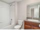 Well-lit bathroom featuring a shower-tub combination, granite vanity, and modern fixtures at 9741 Mulberry Marsh Ln, Sun City Center, FL 33573