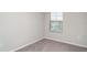 Bedroom featuring neutral carpet and a large window at 9741 Mulberry Marsh Ln, Sun City Center, FL 33573