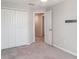Bedroom features neutral carpet and double closets at 9741 Mulberry Marsh Ln, Sun City Center, FL 33573