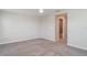 Large bedroom with neutral carpet, a ceiling fan, and access to the bathroom at 9741 Mulberry Marsh Ln, Sun City Center, FL 33573