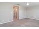 Spacious bedroom with neutral carpet, a ceiling fan, and access to another room at 9741 Mulberry Marsh Ln, Sun City Center, FL 33573