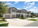 Attractive townhomes featuring a neutral color scheme, attached garages and well-manicured landscaping at 9741 Mulberry Marsh Ln, Sun City Center, FL 33573