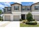 Charming townhome featuring a neutral color scheme, attached garages and well-manicured landscaping at 9741 Mulberry Marsh Ln, Sun City Center, FL 33573