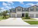 Inviting townhomes with attached garages, neutral exteriors and green landscaping at 9741 Mulberry Marsh Ln, Sun City Center, FL 33573