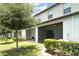Exterior view of multiple screened patios, with lush green grass and manicured bushes in the backyard at 9741 Mulberry Marsh Ln, Sun City Center, FL 33573