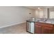 Bright kitchen featuring granite countertops, stainless steel dishwasher, and tile flooring at 9741 Mulberry Marsh Ln, Sun City Center, FL 33573