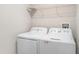 Laundry room includes a washer, dryer and overhead storage shelf at 9741 Mulberry Marsh Ln, Sun City Center, FL 33573