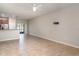 Spacious living room area offering tile floors and sliding glass doors to the exterior at 9741 Mulberry Marsh Ln, Sun City Center, FL 33573