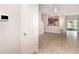 Open concept living space with tile floors, views to the kitchen, and access to the outdoors at 9741 Mulberry Marsh Ln, Sun City Center, FL 33573