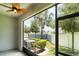 Screened patio offers a ceiling fan and views of the backyard with tropical landscaping at 9741 Mulberry Marsh Ln, Sun City Center, FL 33573