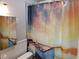 Well-lit bathroom featuring a modern vanity and a stylish shower curtain with a matching mirror at 10160 118Th Ave, Largo, FL 33773