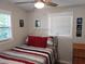 Cozy bedroom featuring a comfortable bed with bright bedding, natural light, and simple decor at 10160 118Th Ave, Largo, FL 33773