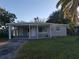 Charming home exterior showcasing well-maintained lawn and carport at 10160 118Th Ave, Largo, FL 33773