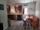Cozy kitchen featuring wood cabinets, granite counters, stainless appliances, and dining nook at 10160 118Th Ave, Largo, FL 33773