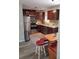Charming kitchen featuring wood cabinets, stainless steel appliances, and a cozy dining nook at 10160 118Th Ave, Largo, FL 33773