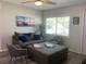 Comfortable living room with modern furnishings, including a plush sofa, chairs, and a view to the front yard at 10160 118Th Ave, Largo, FL 33773