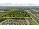 Aerial view of land for sale between neighborhood and wooded area with a yellow rectangular border at 11109 Sumner Rd, Wimauma, FL 33598