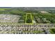 Aerial view of land for sale between neighborhood and wooded area with a yellow rectangular border at 11109 Sumner Rd, Wimauma, FL 33598