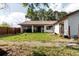 Backyard with green grass, home and metal roof at 11109 Sumner Rd, Wimauma, FL 33598