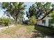 Spacious backyard offering ample space for gardening or outdoor activities, with large mature trees at 11109 Sumner Rd, Wimauma, FL 33598