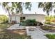 View of the rear of the home featuring a grassy yard and mature trees, offering outdoor space at 11109 Sumner Rd, Wimauma, FL 33598