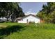View of backyard featuring mature trees, grassy yard and lush greenery, providing lots of space at 11109 Sumner Rd, Wimauma, FL 33598