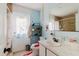 Bathroom with a sink, toilet, and a shower with tiled walls at 11109 Sumner Rd, Wimauma, FL 33598