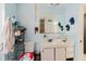 A quaint bathroom featuring a sink, toilet, and a decorative mirror at 11109 Sumner Rd, Wimauma, FL 33598