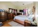 Spacious bedroom featuring wood furniture, a television, and neutral walls at 11109 Sumner Rd, Wimauma, FL 33598