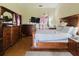 Bedroom with wood furniture and a flatscreen television mounted on the wall at 11109 Sumner Rd, Wimauma, FL 33598