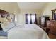 Bedroom showcasing a comfortable bed, matching wood furniture, and natural light at 11109 Sumner Rd, Wimauma, FL 33598