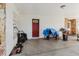 View of the car port featuring a red entry door and miscellaneous items at 11109 Sumner Rd, Wimauma, FL 33598