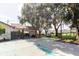 A long driveway leads to a covered parking area surrounded by beautiful mature trees at 11109 Sumner Rd, Wimauma, FL 33598