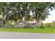 Exterior ground view of house surrounded by mature trees at 11109 Sumner Rd, Wimauma, FL 33598