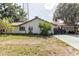 Charming single story home featuring a metal roof, front yard and covered parking at 11109 Sumner Rd, Wimauma, FL 33598